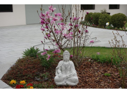 Boeddha-beeld in steenlook. Groot beeld voor decoratie in de tuin.